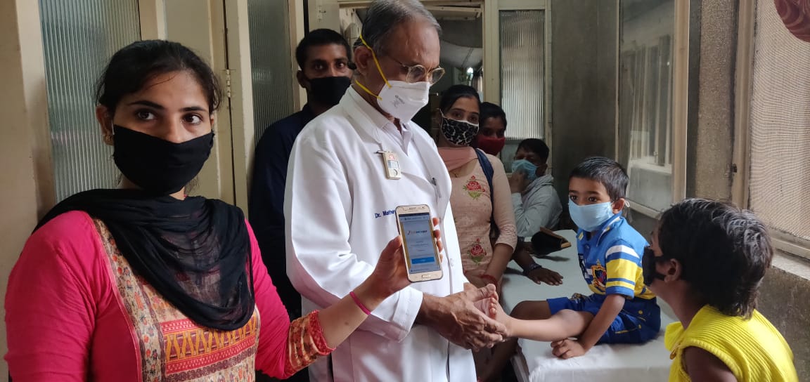 Dr-Mathew-Nishchay-using-the-Nischay-Web-Application-on-his-Phone-while-treating-patients